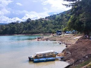 two boats are docked on the shore of a beach at Glamping Tiny house 