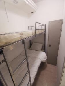 a room with two bunk beds and a door at Cloud9 hostel in Dubai