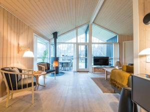 a large living room with a bed and a table at Holiday home Fanø CXXX in Fanø