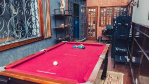 a red pool table in a room with at Urbanature Filme & Arte - Comfort Hostel Brooklin in Sao Paulo