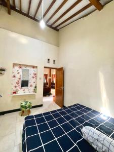 a bedroom with a large blue bed in a room at Villa Sakana - Escape to Paradise in Balong