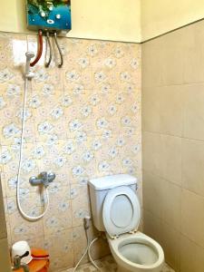a bathroom with a toilet and a shower at Villa Sakana - Escape to Paradise in Balong +8 photos