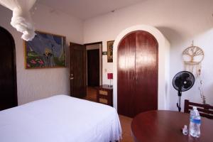 Un ou plusieurs lits dans un hébergement de l'établissement Hotel boutique Teocalli