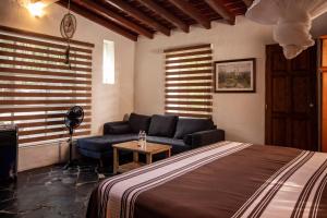Un ou plusieurs lits dans un hébergement de l'établissement Hotel boutique Teocalli