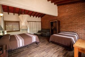Un ou plusieurs lits dans un hébergement de l'établissement Hotel boutique Teocalli