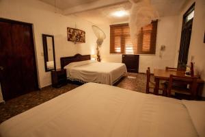 Un ou plusieurs lits dans un hébergement de l'établissement Hotel boutique Teocalli