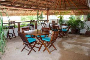 a wooden table and chairs on a patio at Casa TICUL Hotel Boutique - 5Th Ave in Playa del Carmen