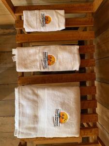 a group of white towels on a wooden rack at PAMPA HERMOSA LAKE RESORT in Puerto Maldonado
