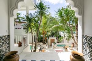 a view of a living room with palm trees at Segredo Uluwatu in Uluwatu