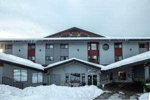 a snow covered building with a lot of snow around it at Prestige Mountain Resort Rossland in Rossland