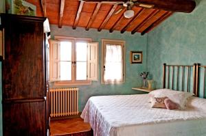 a bedroom with a bed in a room with green walls at Villa Sunflower in Montelupo Fiorentino +51 photos