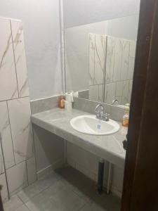 a bathroom with a sink and a mirror at Gallina E Palo Beachfront Hotel in Jacó +24 photos