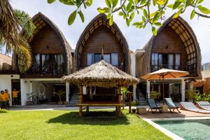 a villa with a swimming pool and a resort at Martas Windows in Kuta Lombok