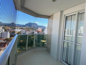 a balcony with a view of a city at apartamento praia do morro - beira mar in Guarapari