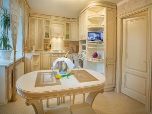 a kitchen with white cabinets and a sink and a counter at Luxury Apartments with Jacuzzi in Sumy