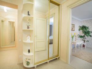 a room with a glass shower with a mirror at Luxury Apartments with Jacuzzi in Sumy