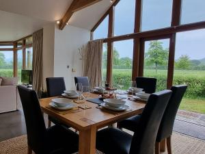 a dining room with a wooden table and chairs at Mow Barton in Wells