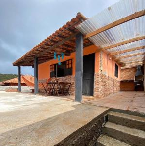 a patio of a house with a roof at Chalé Flor da Serra in Conceição da Ibitipoca