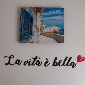a picture of a town with a window and the words la oticaega at Sweet night in bari in Bari