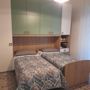 a bedroom with two beds and a cabinet at Sweet night in bari in Bari