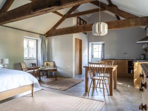 a bedroom with a bed and a dining room at Blackrock Barn in Clifford