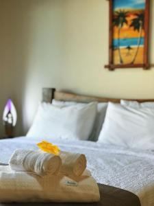uma cama com duas toalhas enroladas em Pousada Villa Kai em São Miguel dos Milagres