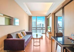 a living room with a couch and a table at Greystone Swiss Garden Residence in Kuala Lumpur
