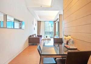 a living room with a dining room table and chairs at Greystone Swiss Garden Residence in Kuala Lumpur