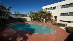 a swimming pool in front of a building at Wickham Point Unit 4 Kings Beach QLD in Caloundra