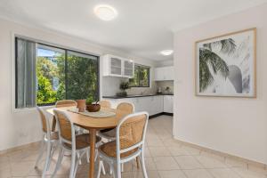a kitchen and dining room with a table and chairs at A Pets Paradise by Experience Jervis Bay in Vincentia