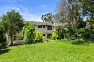 a house with a yard in front of it at A Pets Paradise by Experience Jervis Bay in Vincentia