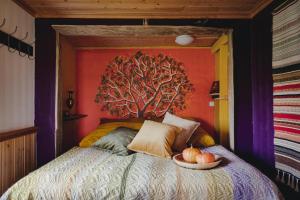 a bedroom with a bed with a bowl of pumpkins on it at Loma-Paksu in Köngäs