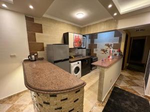 a kitchen with a counter top and a refrigerator at سى فيو السريا in Alexandria