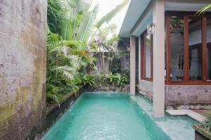a swimming pool in the middle of a house at Prema Uja Villas in Ubud