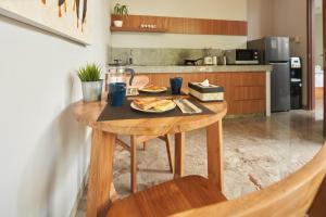 a wooden table with a plate of food on it in a kitchen at Prema Uja Villas in Ubud