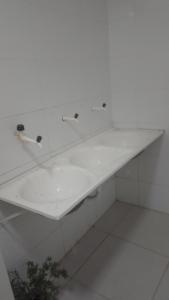 a bathroom with a white sink and a white floor at Casa Village do Sol in Guarapari +27 photos