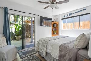a bedroom with a bed and a ceiling fan at Walk on the Ocean! Wake up to Beautiful Bay Views in Newport Beach