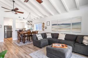 a living room with a couch and a table at Walk on the Ocean! Wake up to Beautiful Bay Views in Newport Beach