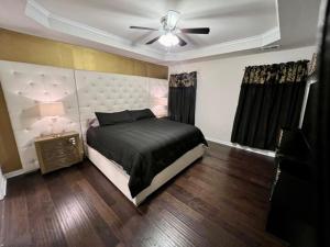 a bedroom with a bed and a ceiling fan at The Muirwood Retreat in Murfreesboro