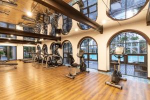 a gym with treadmills and ellipticals in a room with windows at YES! LaCasita Pool View 5 FREE WiFi near the sea in Hua Hin