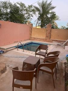 a swimming pool with chairs and a table and a table and chairs at 3 bedroom villa for rent in Hurghada