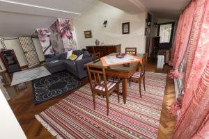 a living room with a table and a couch at Patrian in Grottaferrata