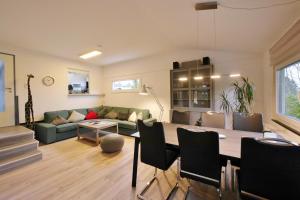 uma sala de estar com um sofá verde e uma mesa em Ferienhaus FREE WILLI em Willingen