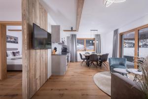 a living room with a kitchen and a dining room at Apartment Streif LXL in Kirchdorf in Tirol