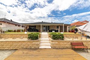 a home with a staircase leading up to a house at Waterfront Haven with your own private jetty in Forster