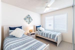 1 Schlafzimmer mit 2 Betten und einem Fenster in der Unterkunft Laman Lodge, 1,15 Laman Street - Stunning Views, air conditioned unit with water views and Wifi in Nelson Bay