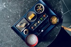 a plate of food on a table with sushi at hotel tou nishinotoin kyoto in Kyoto