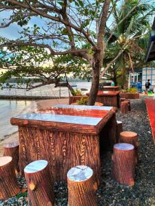 a bar made out of tree stump with stools at Bolo Beach Santorini - an ISOLATED SECLUDED private beach property in Alaminos