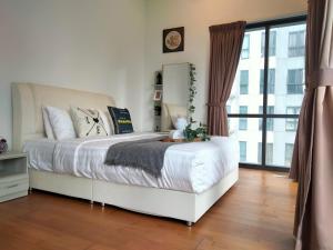 a bedroom with a white bed and a large window at Element Signature Suites 5pax 3Br Ampang KLCC in Kuala Lumpur