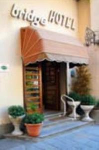 an entrance to a building with plants in front of it at Bridge Hotel in Bagni di Lucca